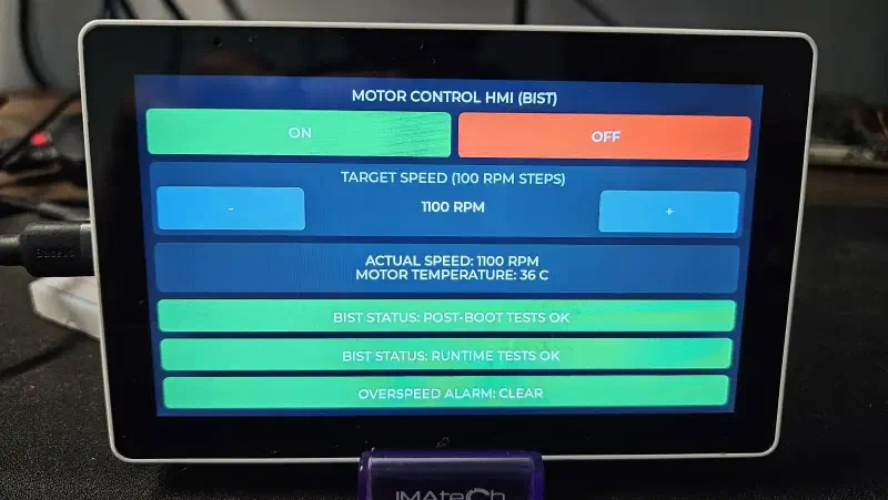 Close-up of the post-boot and runtime BIST status labels on the HMI, both showing a passing state